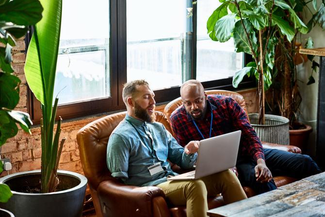 Two men looking at a laptop