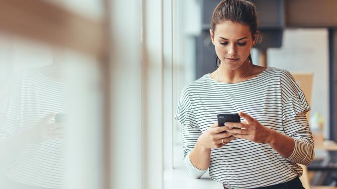 A woman looking at her mobile phone